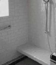 Installed after the rest of the shower had been completed, this tiled bench is supported by a lightweight aluminum frame; it required neither extra framing nor a waterproofing membrane.