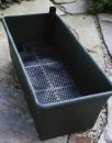 Figure 1. A self-watering container like the one shown above can be easily dropped into a wood frame.