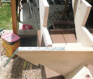 Figure 1. The stair jack, or stringer (foreground, upside down), is cut to extend below the joists. Galvanized-steel strapping is nailed to the jack’s bottom with 10d commons.