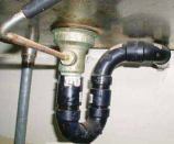 The drain connection at the wall is too high on this sink, resulting in a 9-inch-deep trap seal — 5 inches deeper than is allowed by code.