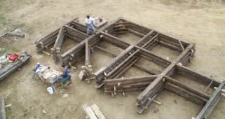 Original barn timbers were re-assembled into bents at the job site. Replacement parts were cut and shaped from locally milled lumber as needed, and surfaced with an adze to remove saw-blade marks.