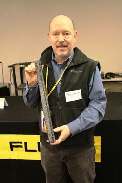 The editor holds a replica of a cubit; this one is approximately 20 5/8 inches long. Foremen had stone cubits – workers' cubits were made from wood.