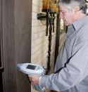 Before starting work, the author tests painted surfaces with a portable XRF analyzer to find out whether lead levels are high enough to require RRP compliance.