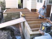 When excavating for the foundation of the addition, the author used the top of the floor joists at the center of the future opening between the addition and the existing house as the benchmark. After forming and pouring the 12-inch-deep by 24-inch-wide footing, the crew laid up the wall using 12-inch-wide concrete block, terminating the top of the wall with a course of 8-inch block. This created a 4-inch-deep inner shelf that was topped with a 4x6 PT mudsill set on edge.