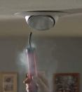 A smoke stick reveals air movement through a recessed fixture in a house depressurized with a blower door. Depending on temperature differential, air can move into or out of the house through can lights.