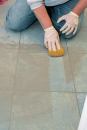 After scrubbing the tile, wipe with a clean sponge, making one pass per side of the sponge before rinsing.