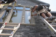Think of a stone veneer as stucco with chunks of concrete embedded in it. Those chunks of concrete absorb and hold a lot of water, so you have to have a system that can drain. Otherwise, all that water held in the cladding will eventually find a way inside.