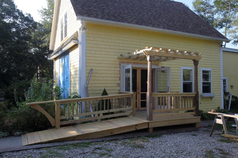 In 2010 I put in new, more weather-tight outswing French doors, as well as a fancier entry with equipment ramp and pergola.