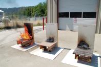 This field demonstration shows the performance of three decking products approximately 35 minutes after a standard 6-inch by 6-inch Class B burning brand was placed on the top surface of each deck. The untreated redwood (far right) and the wood-plastic composite at the center comply with California Building Code Chapter 7A requirements for “combustible” materials, while the wood-plastic composite at the far left does not. None of these products, however, meet the requirements for an “ignition-resistant material” as outlined in the IWUIC, NFPA 1144, or CBC Chapter 7A.