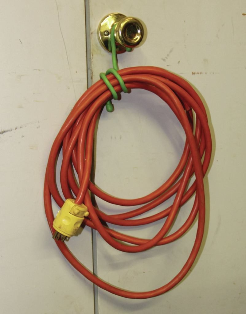 A 12-inch tie is coiled to secure a power cord.
