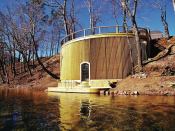 The skirting on this riverside deck is 5/4 by 6-inch PT decking placed vertically and held by blocking at a 45-degree angle to the curved rim joist. The dock on the river's edge is reinforced concrete covered with PT decking.The structure was designed by Barco Construction & Design (barcocd.com) in Doniphan, Mo.
