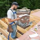 Weatherization tech Scott Phillips cuts coated aluminum coil stock flashing to size for air-sealing a chimney chase on the job with Upright Frameworks (Portland, Maine).