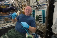 International Space Station Expedition 42 Commander Barry "Butch" Wilmore shows off a ratchet wrench made with a 3-D printer on the station. (Photo by NASA)
