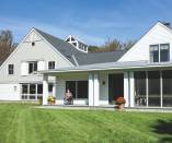 Siting the building close to grade creates a strong connection to the landscape. A no-step entry at the house’s driveway side provides wheelchair access.