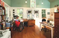 This project room features work surfaces with knee space below, a clear circulation path, a floor free of area rugs and other obstructions, and plenty of natural light.