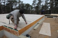 Before the exterior walls can be built, careful measurements have to be taken to locate the exact positions of the walls.