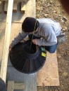 New footings were needed to support a family room addition. After the author removes the old posts and temporarily supports the structure, a plumb line locates the exact position of the footing form. Here, he draws the position on the concrete slab that he needs to remove before digging for the footing.
