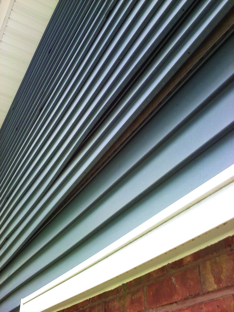 In older two-story homes with vinyl siding, it’s common to see siding panels that have uncoupled between floors. Shrinkage in the structure behind the siding is most likely the cause.