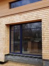 Different wall strategies required different exterior casing strategies for the upper and lower walls on this passive house. Photo by Roe Osborn