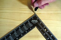 After setting rise and run stair gauges, place a square against the board and mark the heel.