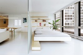 In this renovation of Unit 3E in Chicago, local architecture firm Vladimir Radutny Architects used glass partitions and open shelving to keep this 750-square-foot unit feeling light and airy.