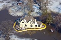 Sandbags supply emergency protection for a house in flooded farmland near the Red River in Hendrum, Minnesota, in March 2009.