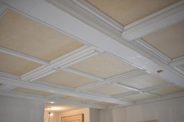 A first cousin of a coffered ceiling, a paneled ceiling is a great way to dress up a room of any size, such as a living room in an open floor plan.