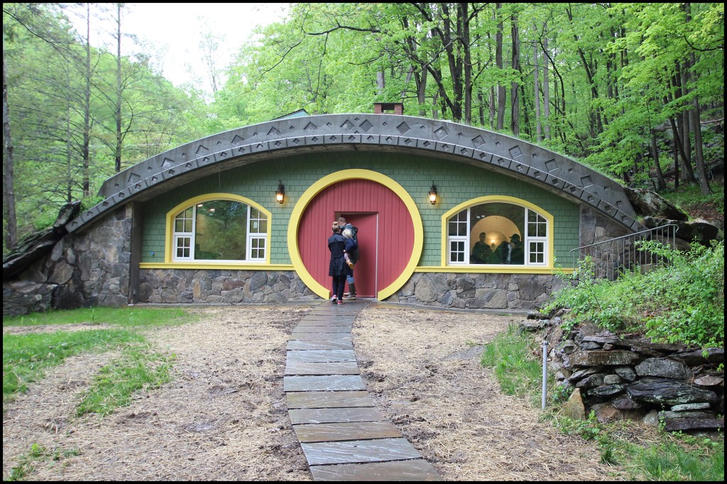 Above is the Hobbit home’s front facade. Built to Passive House standards, the home’s features include low air infiltration; super-insulated walls, roof, and floor; high-performance windows and exterior doors; energy recovery ventilation; and ADA accessibility (inside and out).