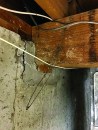 The main girder for the house was sitting in an oversize beam pocket with cracked parging around it.