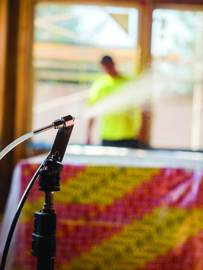 Nozzles inject AeroBarrier adhesive sealant into the air  of a building under 100 pascals of pressure, along with  humidity and heat. The caulking builds up and coagulates  at air-leakage points, sealing small holes in minutes.