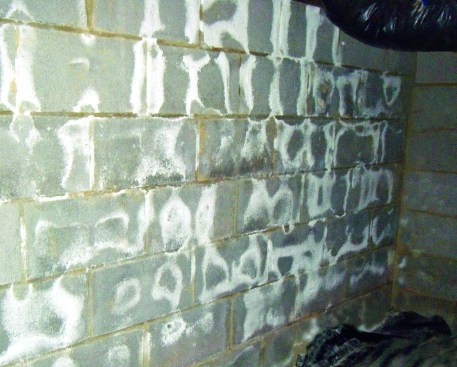 Unsightly salt. White deposits on concrete block are salts that leach from the block as moisture passes through. The deposits don’t do any structural damage to the block, but should be dry-brushed off and thrown away.