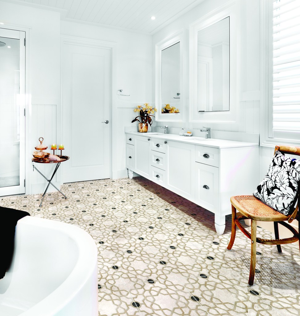 Bathroom of a luxury house having empty bath tub and a wooden chair