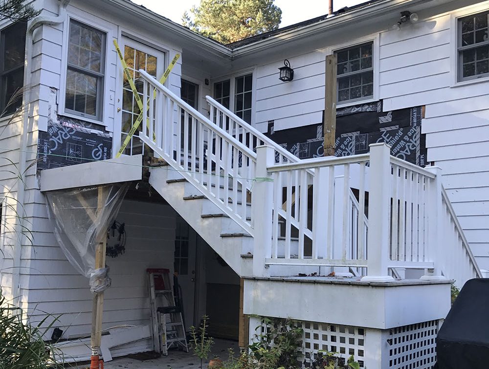 The original deck acted as a porch roof for a ground-level entry to the home, and had been waterproofed with an EPDM membrane laid over plywood sheathing.
