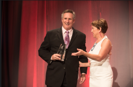At the Awards Gala in New Orleans, Steve Barkhouse receives the 2018 Impact Award from Victoria Downing, president and chief inspiration officer of Remodelers Advantage.