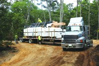 The parts for the house come on big flatbed trailers, shrink-wrapped, labeled, and numbered for assembly.