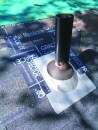 Tape the metal boot to the shingles on the sides and up onto the roof underlayment.