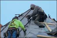 Standing seam roofing panels are installed on a turret roof in Northern Vermont by Dusty Morrits (left) and Dalton Haskins (right) of Evergreen Roofing based in Colchester, VT.