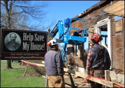The author’s company, Building Heritage, was tasked with documenting, carefully dismantling, and storing the historic farmhouse for a later restoration on a new site. The restored General Stannard House is to serve as a key location on the newly-formed “Vermont in the Civil War Heritage Trail”. Here, author Eliot Lothrop (right) talks with project volunteer, Alex Fenton, (left) on site. Dan Lee of Building Heritage begins removing the home’s wide board sheathing from a personnel lift.