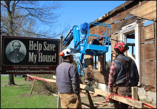 The author’s company, Building Heritage, was tasked with documenting, carefully dismantling, and storing the historic farmhouse for a later restoration on a new site. The restored General Stannard House is to serve as a key location on the newly-formed “Vermont in the Civil War Heritage Trail”. Here, author Eliot Lothrop (right) talks with project volunteer, Alex Fenton, (left) on site. Dan Lee of Building Heritage begins removing the home’s wide board sheathing from a personnel lift.