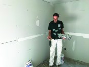 For the prep work, the author carries a utility knife, a screw gun, and a few screws in addition to a mud pan and a 6-inch taping knife.