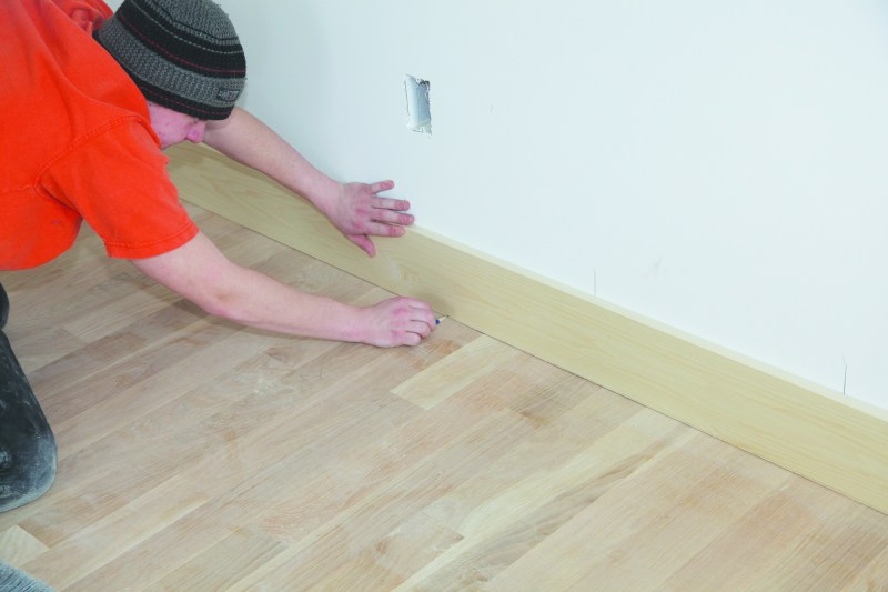 Scribing is a practice where a carpenter fits a finish element to an irregular or uneven surface. One common scribe is fitting baseboard to a hardwood floor.
