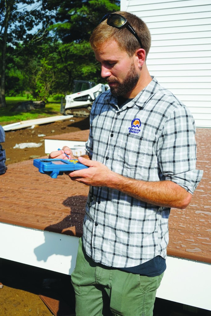 ReVision Energy’s Thomas Tutor demonstrates use of the Solmetric SunEye for determining solar exposure.