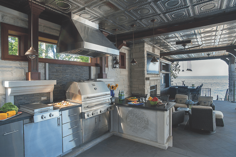 This outdoor cooking area on Chicago's North Shore centers on a combination gas-wood-charcoal grill.