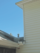 An addition attached to the side of a two-story Colonial created a poorly draining valley, destined to leak. The plumbing vent located in the valley doesn't help.