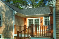 Narrow overhangs rely on gutters to help keep water off the siding.
