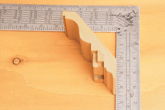 With the top of the square as the ceiling, the rise of the crown molding is measured to the bottom of the crown.
