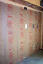 Kraft paper is a better choice than poly for a vapor retarder in a cold climate, because it won't trap summer-time moisture coming from outside an air-conditioned building. The permeability of Kraft paper increases as relative humidity increases. If humidity is high, the permeability of the paper increases and allows the wall to dry out. Photo by Tom Brick.