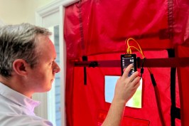Image of man using tester device.