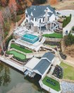 This lakeside building site drops 100 feet from the road to the waterfront. To optimize the lot, the author created three level tiers with a series of retaining walls and connected the tiers to each other with stone steps and pathways.