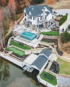 This lakeside building site drops 100 feet from the road to the waterfront. To optimize the lot, the author created three level tiers with a series of retaining walls and connected the tiers to each other with stone steps and pathways.